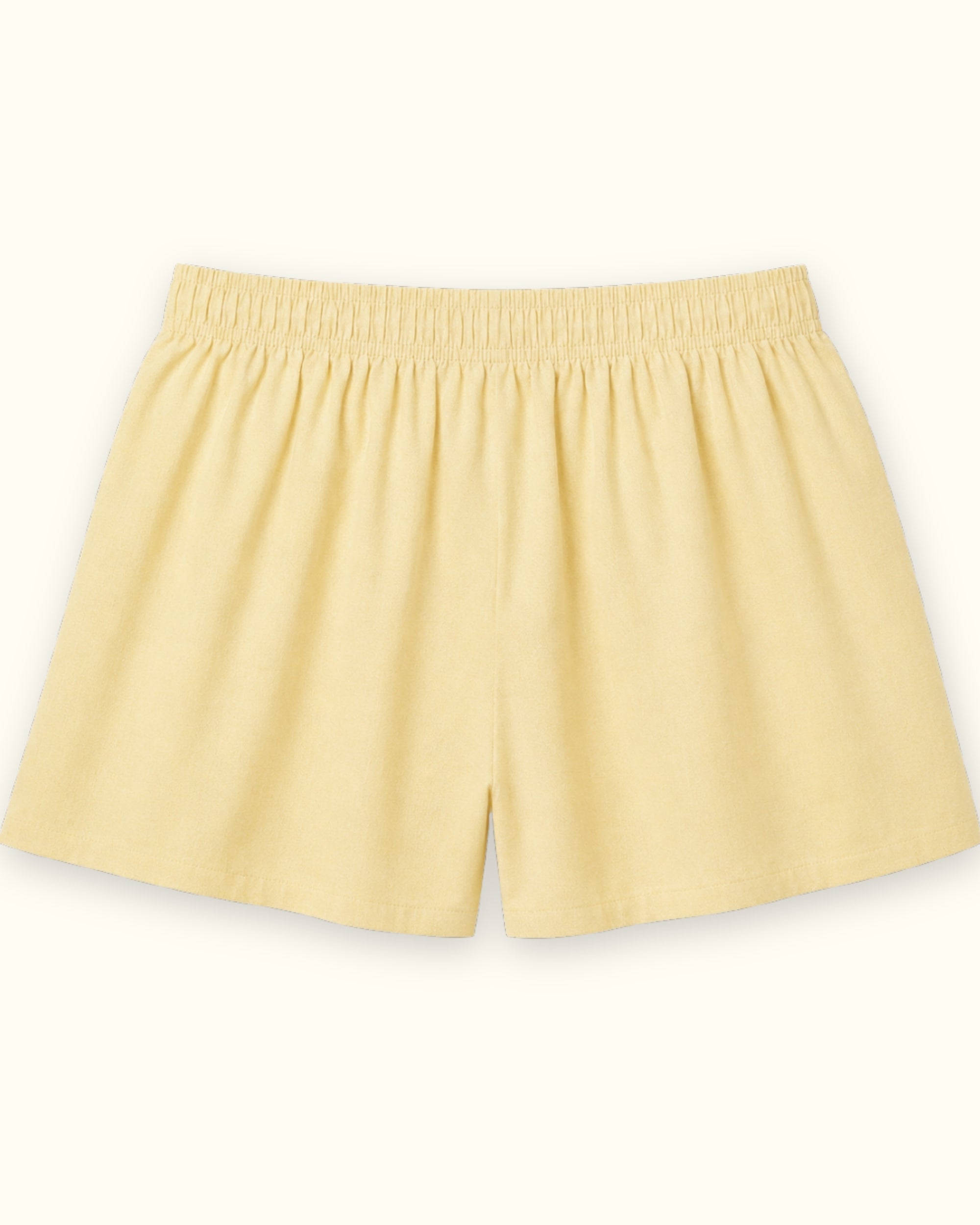 Short tipo bóxer de algodón en Oxford amarillo claro, vista trasera, mostrando la cintura y la forma de la pernera